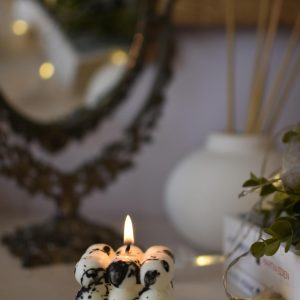 Close-up of a unique bubble candle lit indoors, creating a relaxing ambiance.