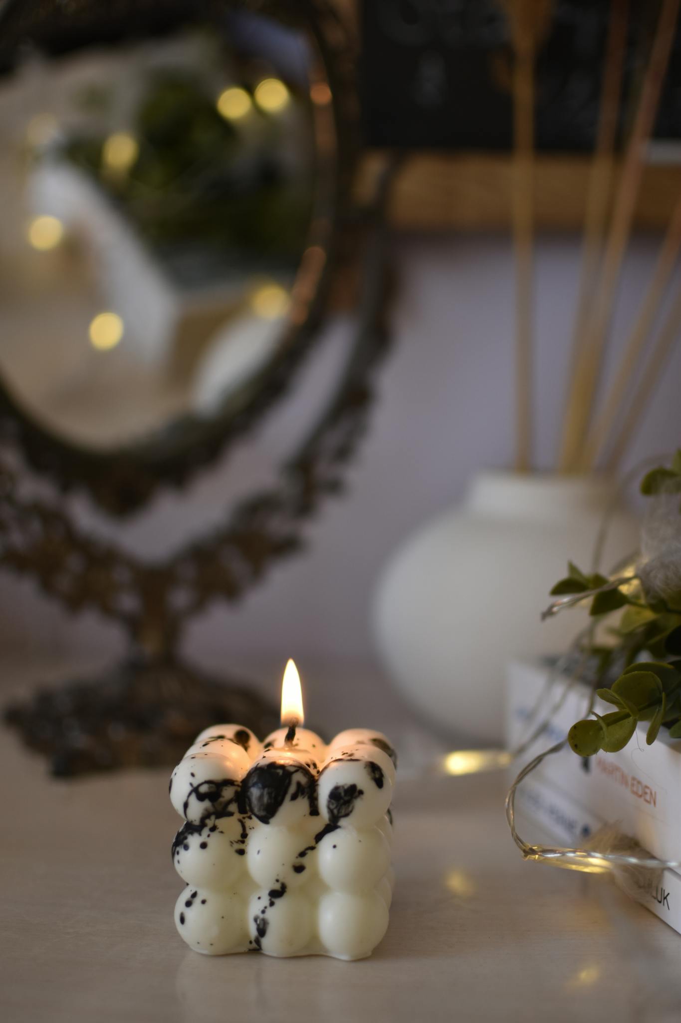 Close-up of a unique bubble candle lit indoors, creating a relaxing ambiance.