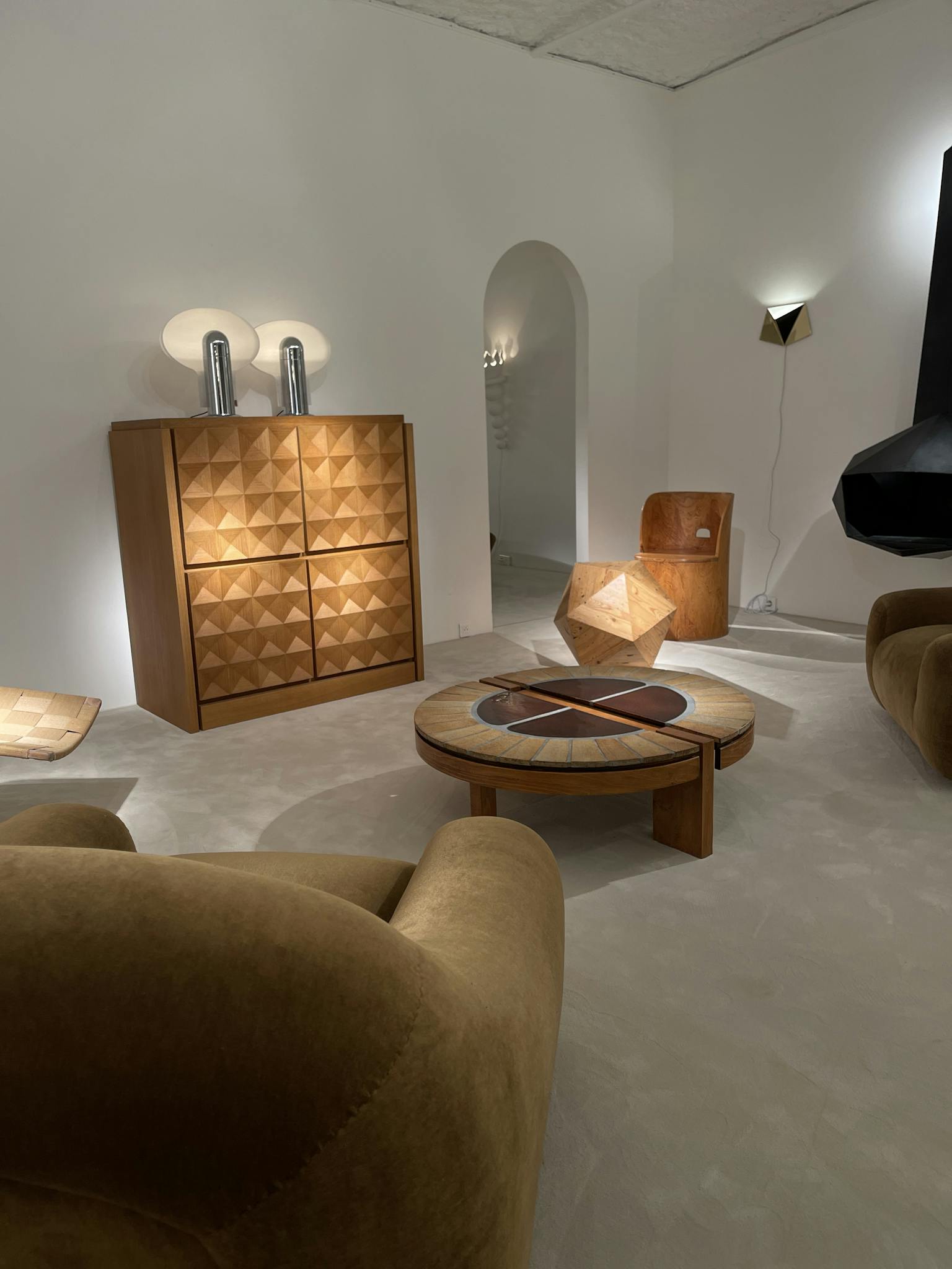 Stylish modern interior with geometric furniture, warm lighting, and unique design elements.