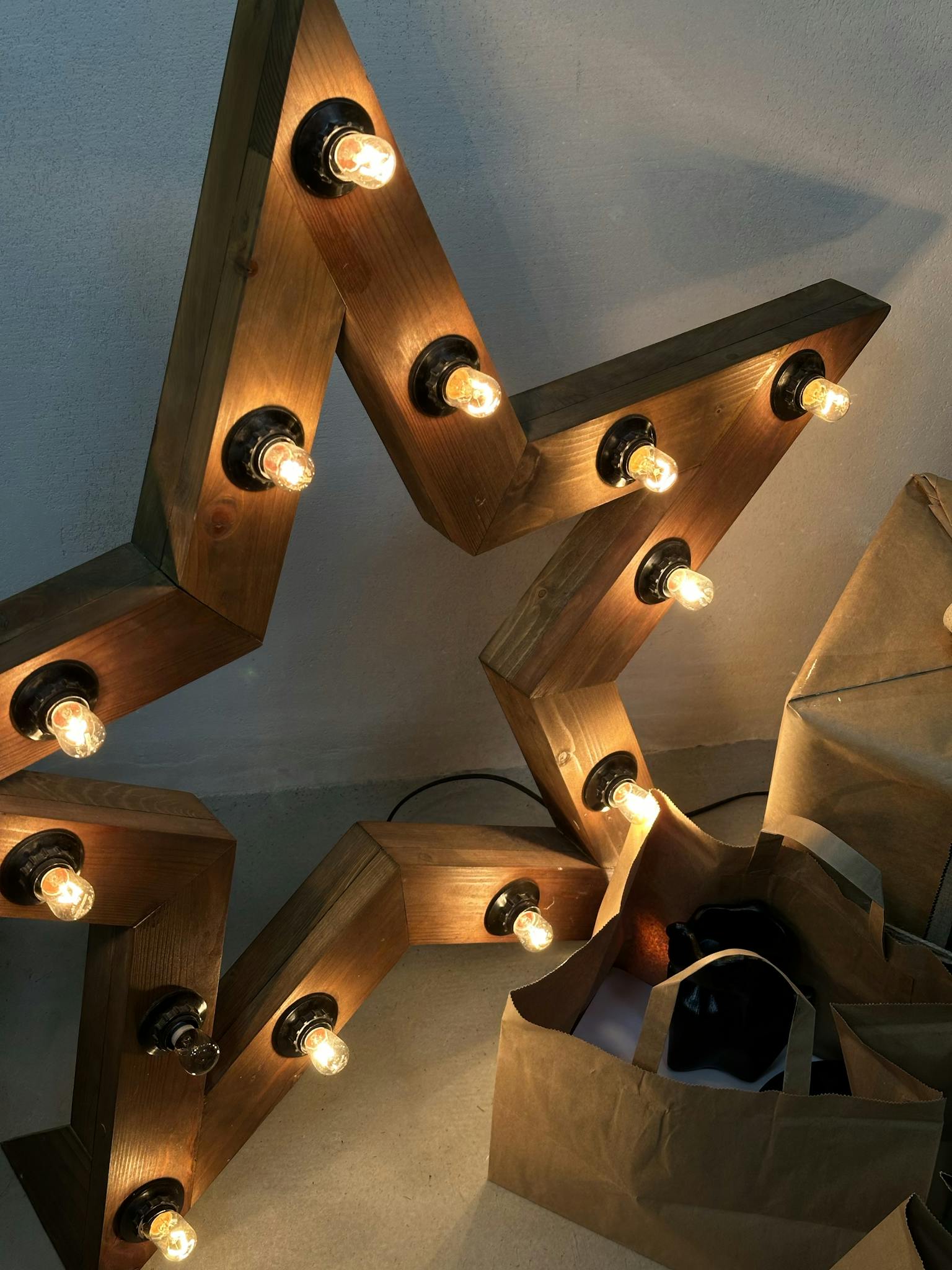 Warm wooden star lamp with glowing bulbs, perfect for home decor.